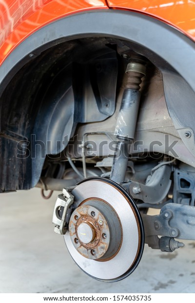 Rear disk\
brake on car in process In the\
garage