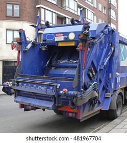 Rear End Of Big Blue Garbage Dump Truck In City