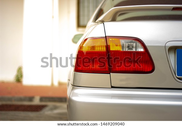Rear gold car With red tail\
lights