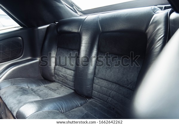 rear leather seats of a coupe convertible car.\
luxury car interior.