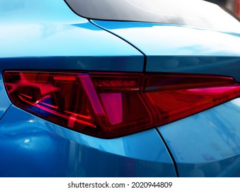 Rear LED headlamp of a modern car. Brake taillight. Red stop lighting of highway vehicles. Cars ambient lighting. Cars taillight decorative frame ABS plastic
