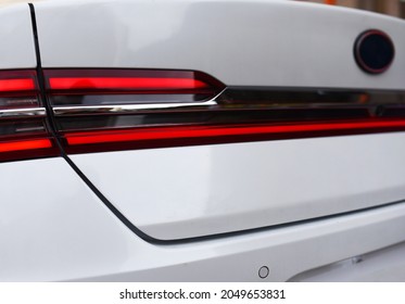 Rear LED headlamp of a modern car. Brake taillight. Red stop lighting of highway vehicles. Cars ambient lighting. Cars taillight decorative frame ABS plastic