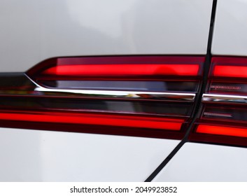 Rear LED headlamp of a modern car. Brake taillight. Red stop lighting of highway vehicles. Cars ambient lighting. Cars taillight decorative frame ABS plastic