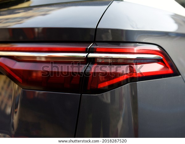 Rear LED headlamp of a modern car.\
Brake taillight. Red stop lighting of highway vehicles. Cars\
ambient lighting. Cars taillight decorative frame ABS\
plastic\
