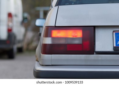 Rear Left Flashing Orange Indicator Light On A Modern Sedan Car In A Close Up View On The Lens Or The Lamp Unit And Bodywork Indicating A Turn