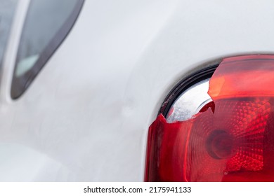 The rear left lamp of a white car is broken. The taillight of the car was shattered in the accident. Damage accident. Security concept. Rear stop of a car in an accident close-up