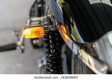 Rear Lens Of Left Turn Light On Vintage Motorcycle Shines Bright As A Warning To Other Drivers.