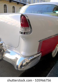 Rear light and bumper detail of a classic American car from 1950s.