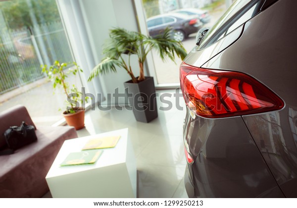 Rear\
light. Throat for fuel filling. Buying a new car in the showroom.\
Paperwork on the car. Purchase and sale\
transaction.