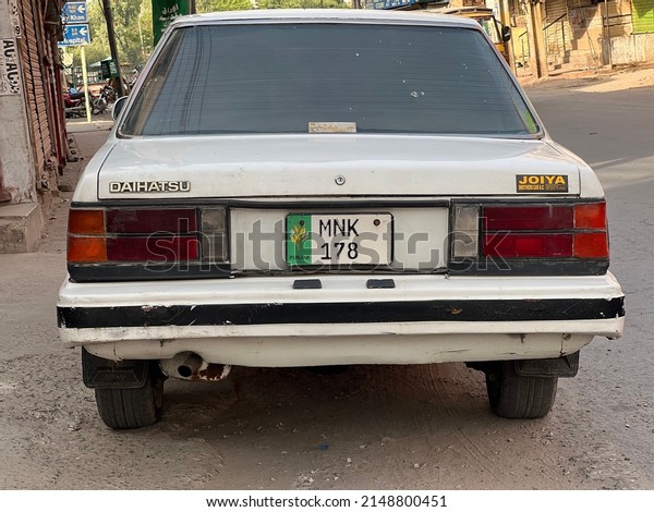 Rear of an old car type Daihatsu,\
in white color. Parked car. Multan, Pakistan. 04. 11.\
2022.