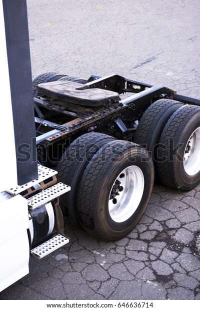 The rear part of the big rig semi truck with a\
frame on which the fifth wheel for connecting to the trailer is\
fixed and the twin driving axles on the ends of which there are two\
wheels with new tires