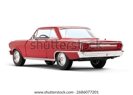 Rear and partial left side view of a Red colored muscle model toy car photographed on a white background.