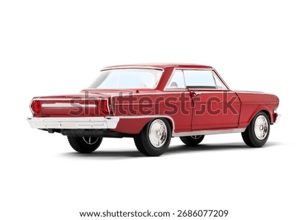 Rear and partial left side view of a red colored musscle model toy car photographed on a white background.