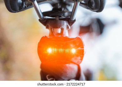 The rear red light on the bike glows brightly