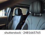 The rear seat in a vehicle is equipped with a headrest and armrest for added comfort during travel