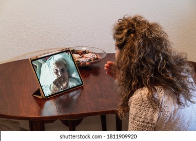 Rear Shot Of A Spanish Woman Making A Video Call On A Tablet With Her Mother Infected With Coronavirus COVID 19 While Staying At The Hospital Thanks To The Volunteer Team That Make That Calls