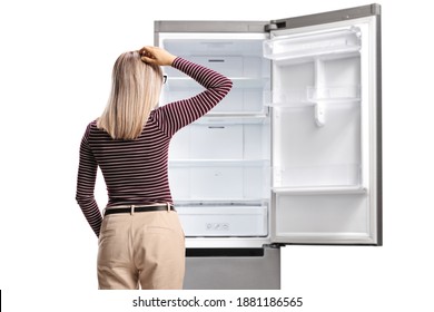 Rear Shot Of A Woman Holding Her Head And Looking At An Empty Fridge Isolated On White Background