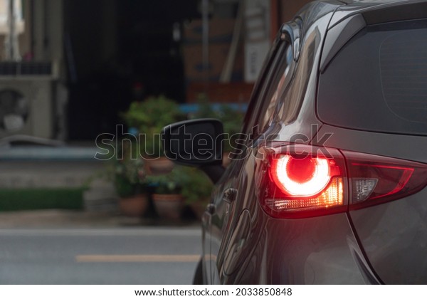 Rear side\
of car turn on light brake with light signal. Prepare for turn left\
on the asphalt. Environment in the\
city.