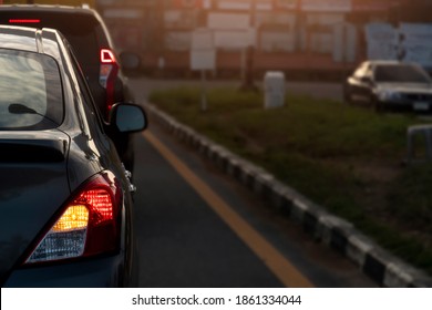 Rear side of cars on the road. Stop and open light brake with turn signal light. for U-turn on the asphalt road. Environment and evening light