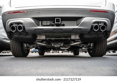 Rear Side Of A Vehicle. Exhaust System In Brand New Modern Car. Automotive Industry Theme.