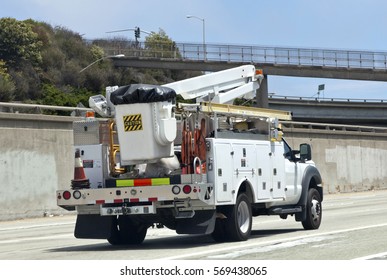 Rear And Side View Of Utility Truck With Boom Cherry Picker On Highway.