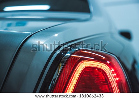Rear tail light of stylish luxury car with pinstripe details. Close up view of classy prestigious vehicle.