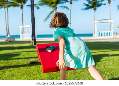 Rear View Of 5 Year Old Boy Tossing Beanbag