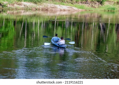 Rear View From Above For Two Kayakers On River Paddle Up Kayak Tracks On Water