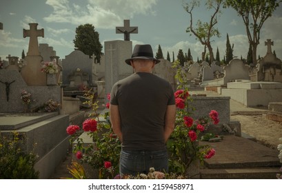 Rear View Of Adult Man Mourning In Cemetery.