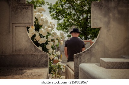 Rear View Of Adult Man Mourning In Cemetery. Madrid, Spain