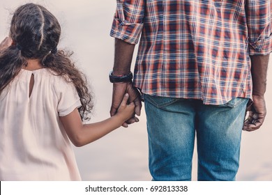 Rear View Of African American Grandfather Holding Hands With Granddaughter  