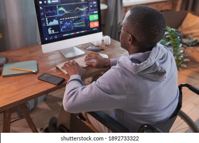 Rear View Of African Disabled Man Typing On Computer Developing New Software While Working At Home