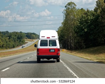 Rear View Of Ambulance Emergency Vehicle On Highway. Horizontal.