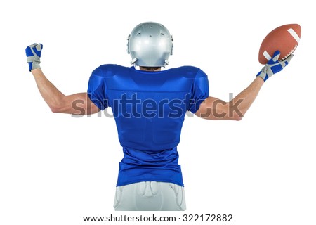Rear view of American football player holding ball against white background