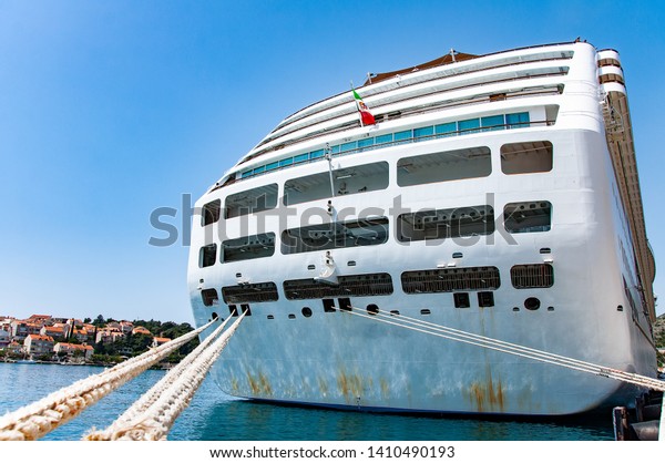rear view of anchor cruise in port.\
Big cruise ship in harbor, read view to big anchor\
ropes.