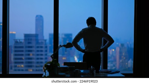 Rear view - Asian business man being frustrated standing in office hopelessly