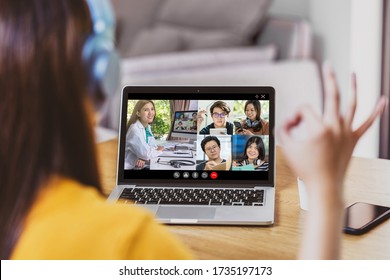 Rear View Of Asian Business Woman Discussing With Doctor And Teamwork Colleague To Follow Up Sickness In Video Conference When Coronavirus Outbreak, Covid-19 Pandemic,online Meeting And New Normal