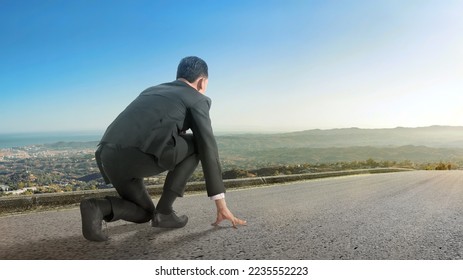 Rear view of Asian businessman in start position ready to run with blue sky background - Powered by Shutterstock