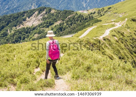 rear view of Asian mountain climbing woman walking at a path in Hehuan mountain, Taiwan