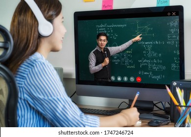 Rear View of Asian student learning with teacher over the physics formular in thai laguage on black board via video call conference when Covid-19 pandemic, education and Social distancing concept - Shutterstock ID 1747246724