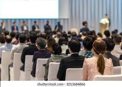 Rear view of Audience in the conference hall or seminar meeting which have Speakers on the stage, business and education about investment concept