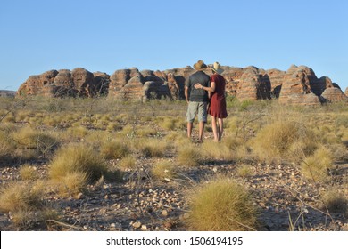 Rear View Of Australian Traveler Couple Hugging Outdoor Looking At The Landscape View Of Bungle Bungle Range Landform Coutryside In Kimberley Western Australia. Real People. Copy Space