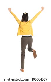 Rear view or back of an Asian girl arms up happy jumping around, full length standing isolated on white background.