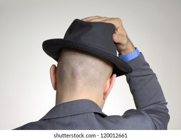 bald man with hat