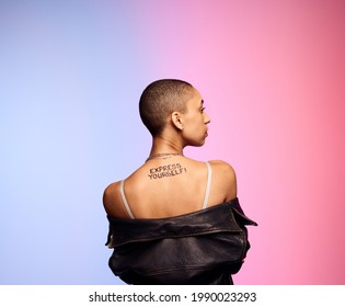 Rear View Of Bald Woman On Colorful Background. Androgynous With Short Hair And Express Yourself Written On Back.