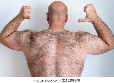 Rear view of the bare and hairy back of a middle aged Caucasian man.