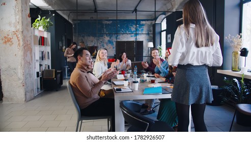 Rear View Beautiful Successful Young 20s Blonde Female Coach Entering Multiethnic Office Team Meeting At Loft Coworking.