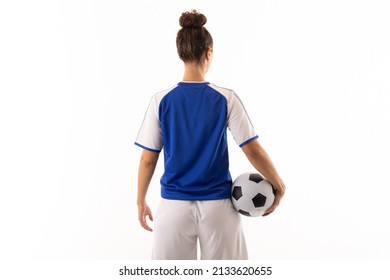 Rear view of biracial young female soccer player with soccer ball standing against white background. unaltered, sport, sports uniform, copy space, athlete and women's soccer. - Powered by Shutterstock