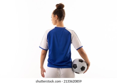 Rear view of biracial young female soccer player with soccer ball standing over white background. unaltered, sport, sports uniform, copy space, athlete and women's soccer. - Powered by Shutterstock