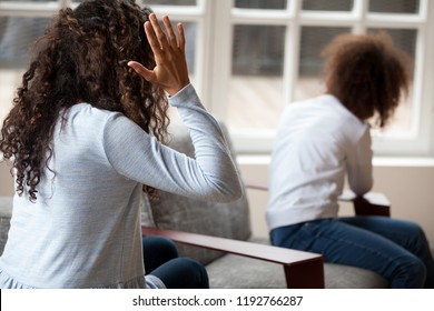 Rear view of black single African mother screaming shouting to little preschool daughter. Complicated relationships with child upbringing misunderstanding family conflict and child punishment concept
